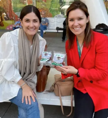 Two women smiling while holding it’s-it