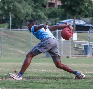 Man playing kickball