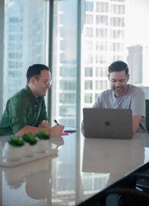 A woman in a purple shirt listening to her coworker