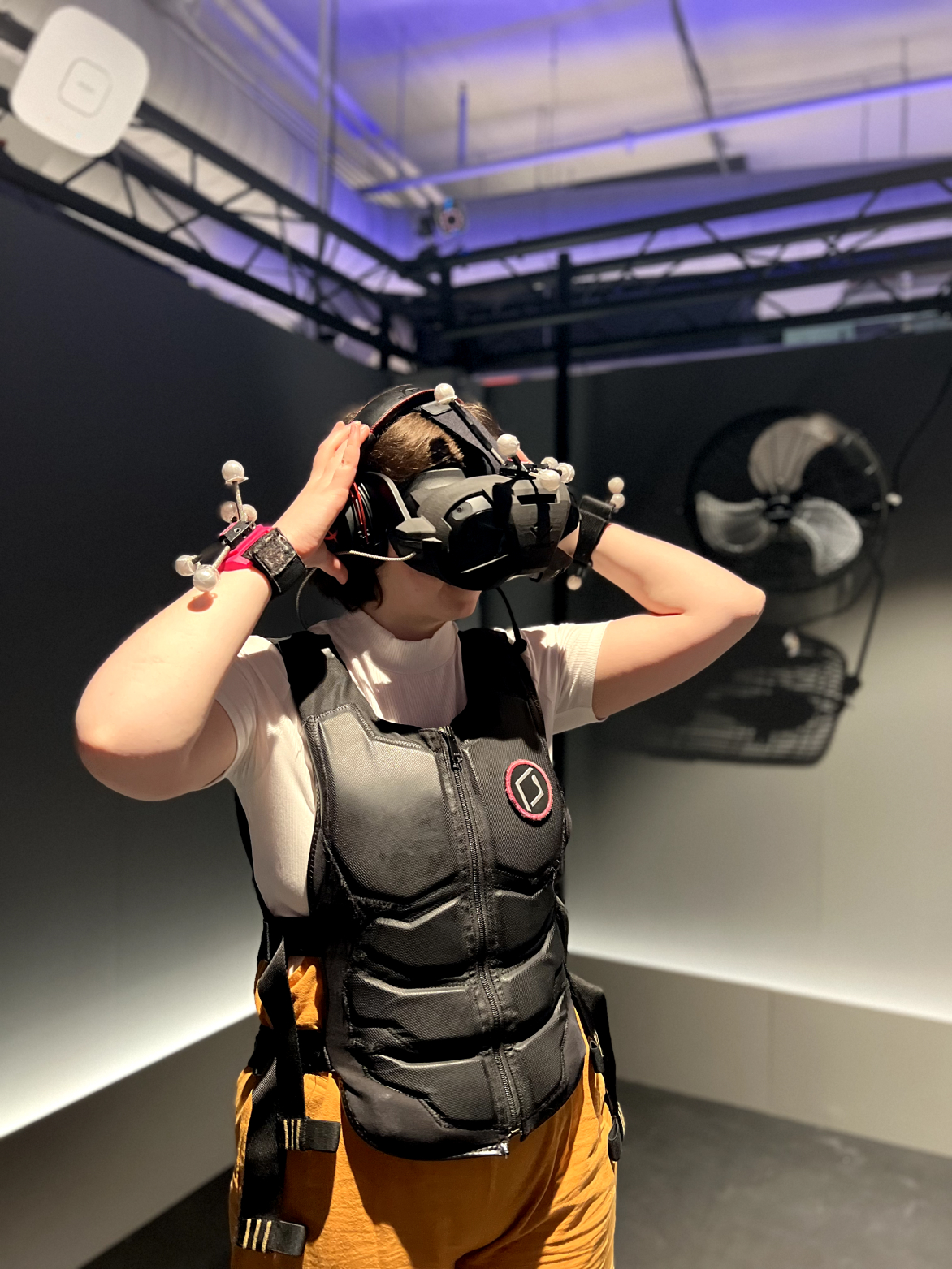 A person wearing a VR headset and motion capture suit during a team-building event, demonstrating Sagepath Reply's innovative corporate culture.