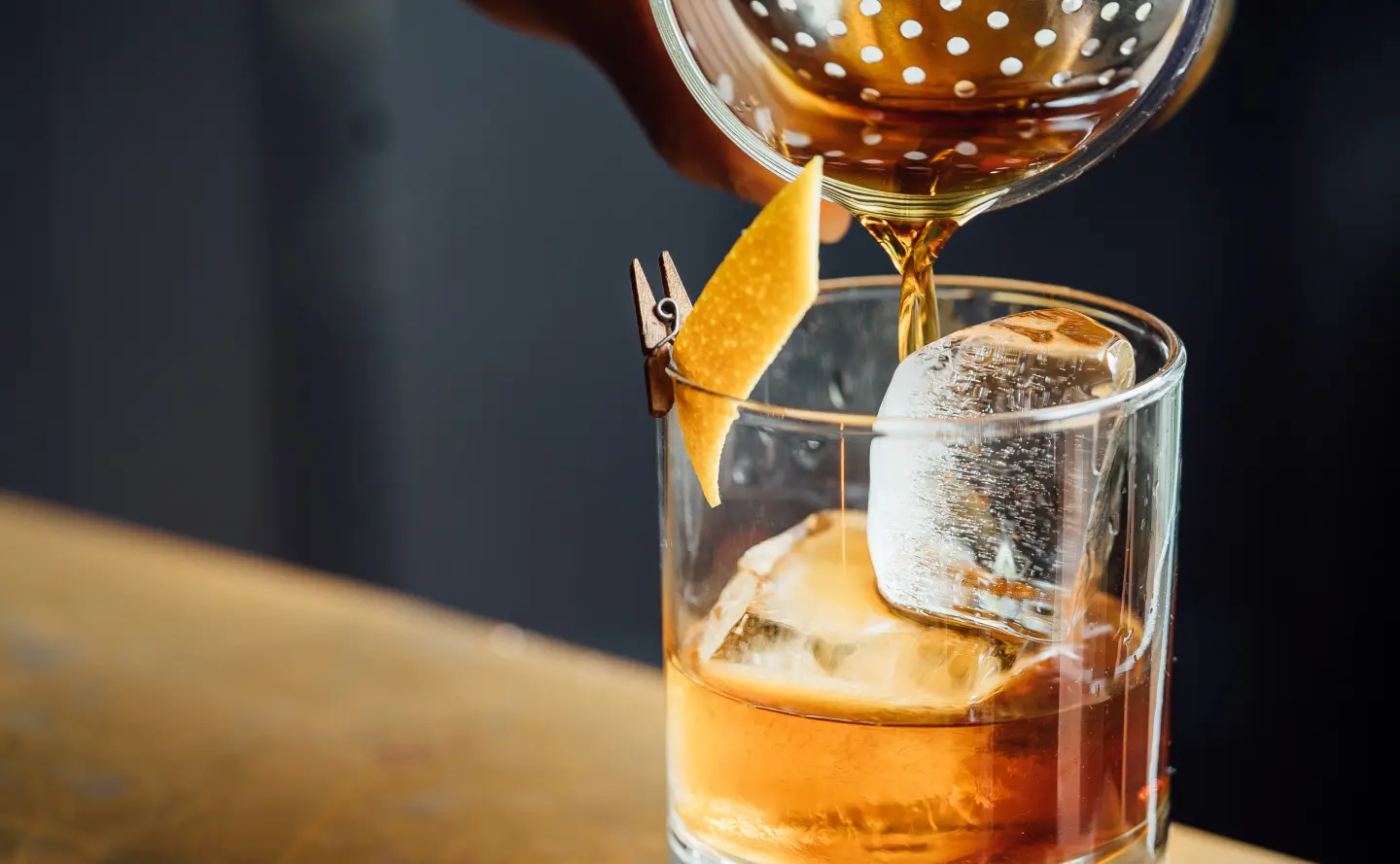 Sazerac bourbon pouring into rocks glass