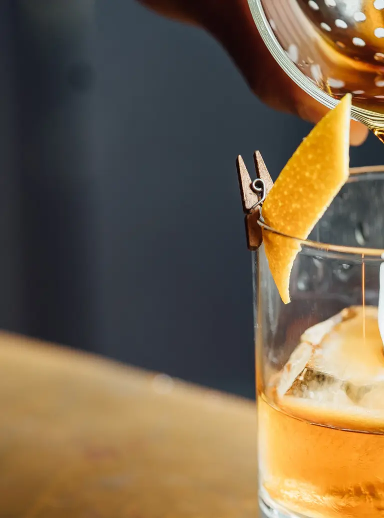 Sazerac bourbon pouring into rocks glass