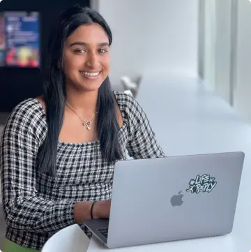 Girl smiling with macbook