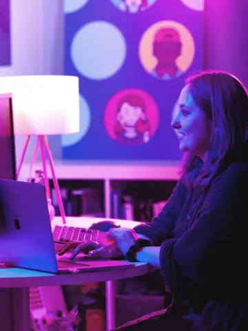 Celine Macke, Developer at Sagepath, playing online video games on laptop